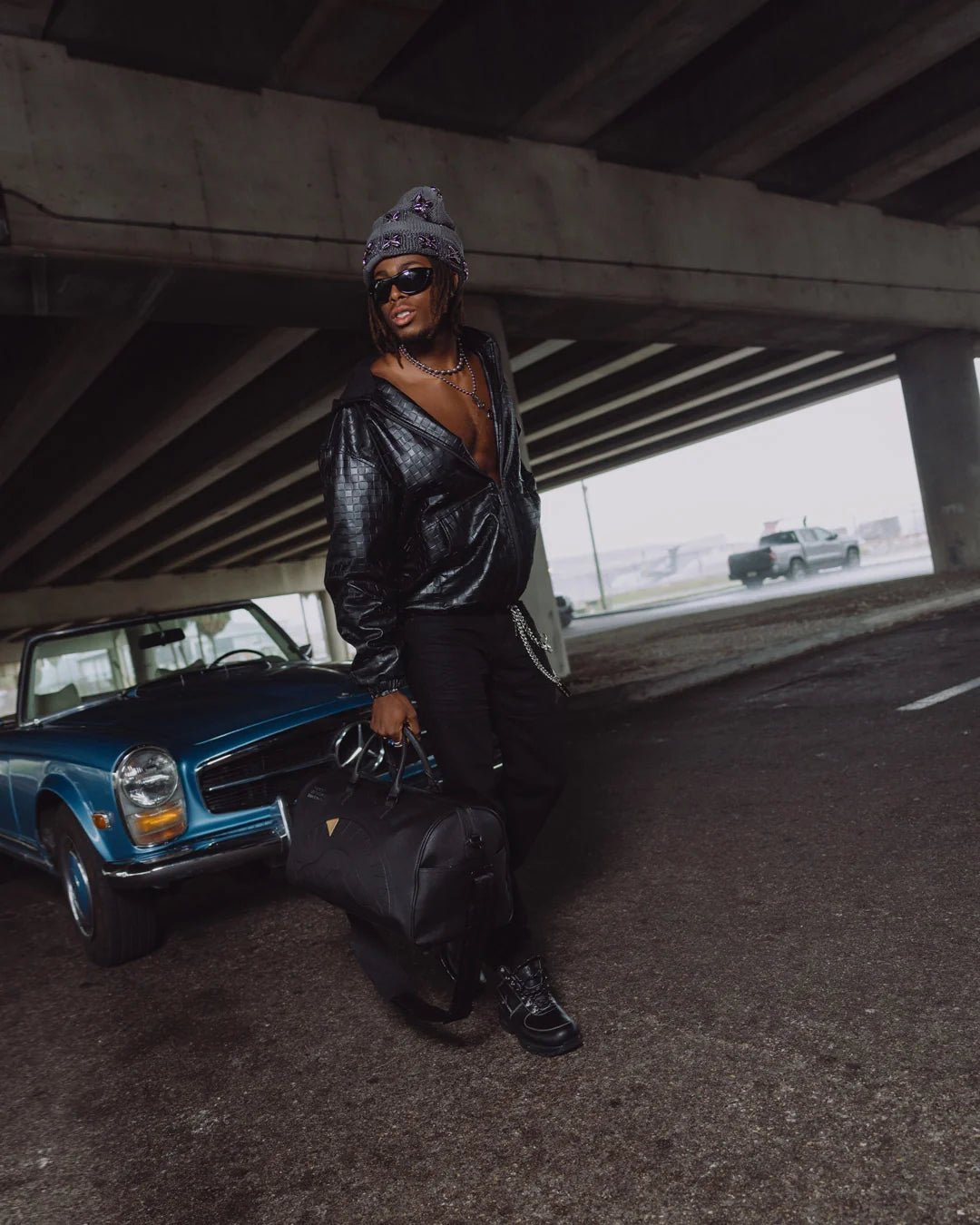 BLACKED OUT EMBOSSED GOLD TOOTH DUFFLE