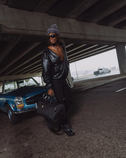 BLACKED OUT EMBOSSED GOLD TOOTH DUFFLE
