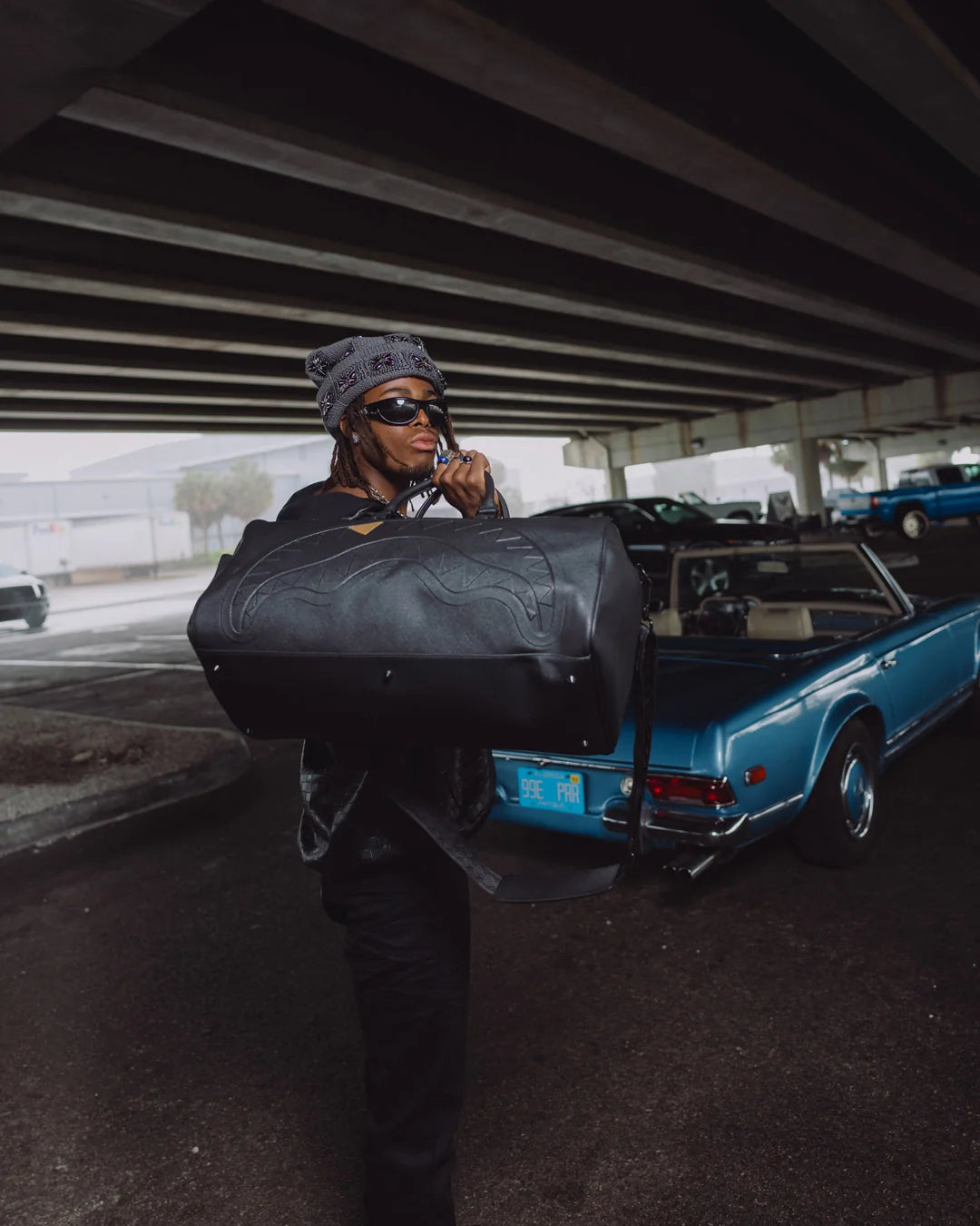 BLACKED OUT EMBOSSED GOLD TOOTH DUFFLE