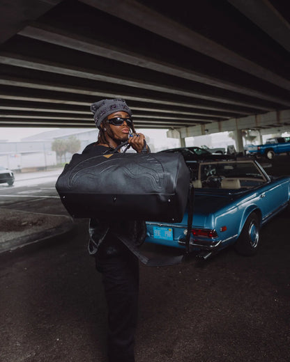 BLACKED OUT EMBOSSED GOLD TOOTH DUFFLE
